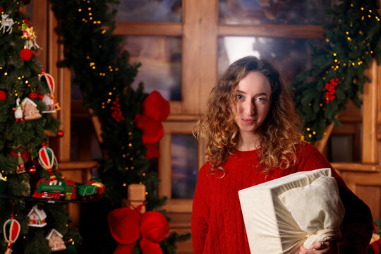 beautiful young woman portrait in colorful cottage Christmas room holidays background light glare