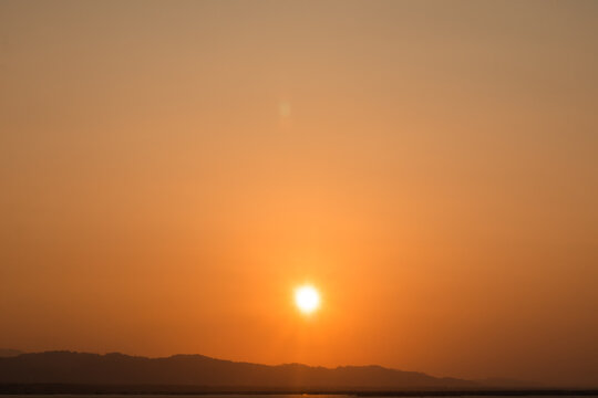 Golden Sunset Over Distant Mountains