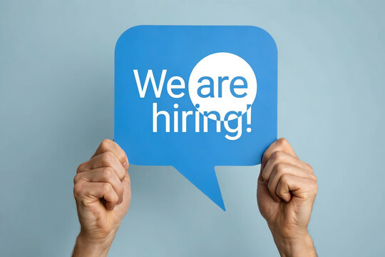 We are hiring blue speech bubble sign held by hands photo illustration