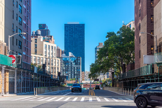 Manhattan street with cars and buildings on a sunny morning