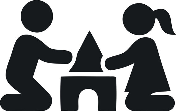 A simple black silhouette icon of a young boy and girl playing together with building blocks on floor