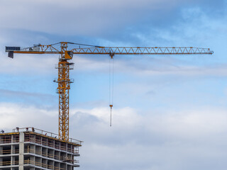Tower crane at a construction site against the sky © Dmitrii Potashkin