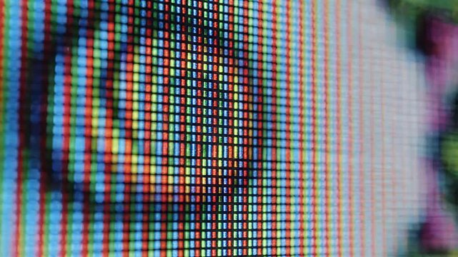 Extreme close-up of a digital screen showing a colorful pixelated human eye