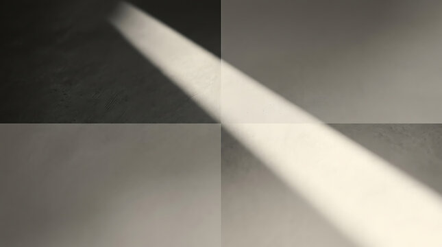 Abstract architectural surface divided into four quadrants with a bright diagonal ray of light cutting across dark textured panels