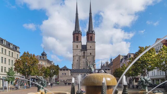 historical square &ldquo;Hallmarkt&rdquo; in Halle (Saale) with G&ouml;bel Fountain in foreground on a sunny day, wide angle time-lapse with motion blur, Saxony-Anhalt, Germany, 2026