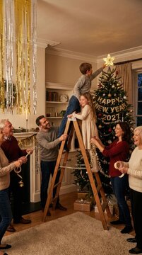 New Year anticipation: look forward, prepare happy, star placement, ladder climb, family decorate, winter 2027, holiday hope, home gathering, gold ornament.