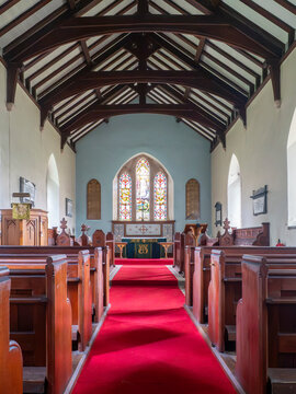 27th September 2026, Embleton, Cumbria. The interior of Saint Cuthberts Church features a vibrant red carpet leading to the altar, flanked by traditional wooden pews under a beamed ceiling.