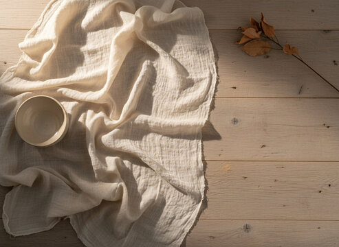 Raw silk with natural slubs, surfaces showing honest wear and use, soft directional daylight