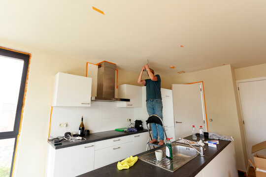 Man Installing Ceiling lamp
