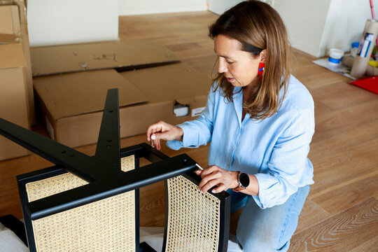 Woman Assembling a Piece of Furniture