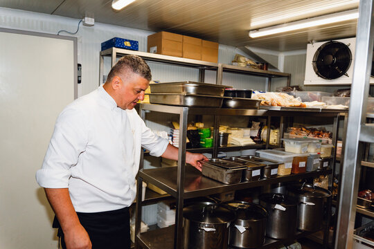 Kitchen Staff Organizing Food in a Storage Room