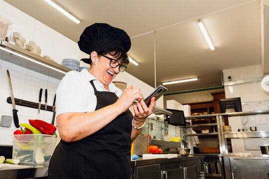 Kitchen Worker Using Smartphone