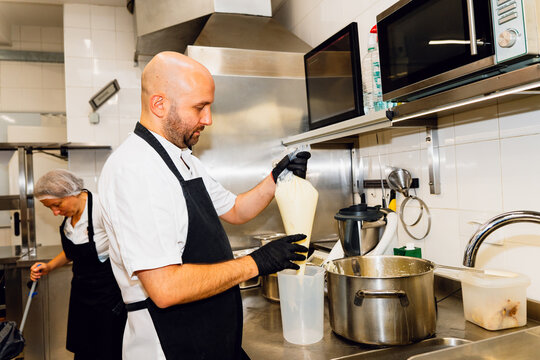 Chef Preparing Cream in a Professional Kitchen