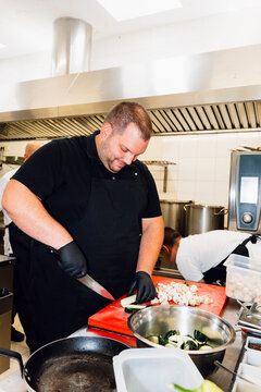 Chef slicing zucchini