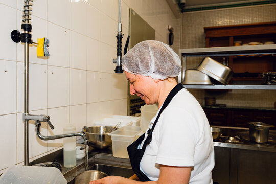 Washing dishes in kitchen