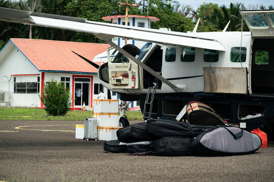 Surfboards and Luggage Loaded Beside Small Aircraft