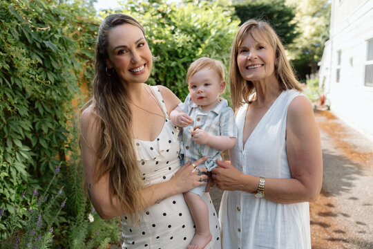 Candid three generation family portrait with smiling baby