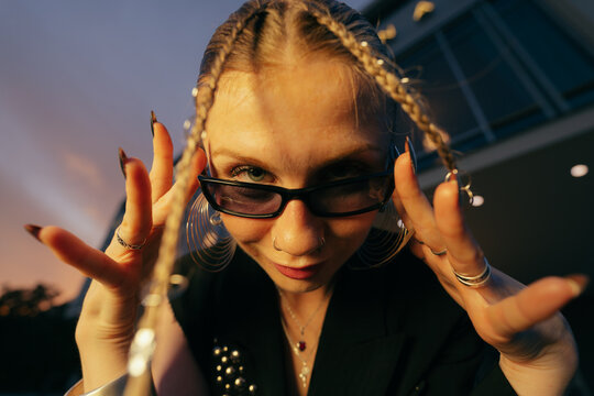 Edgy Woman Adjusting Sunglasses Outdoors