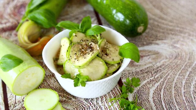 Homemade marinated zucchini with parsley on rustic wooden background