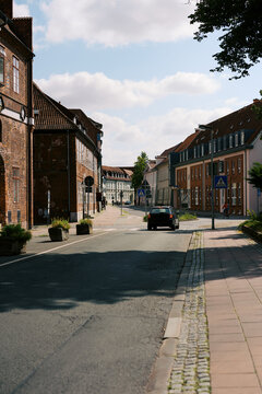 Car driving on city road in L&uuml;neburg, Lower Saxony, Germany