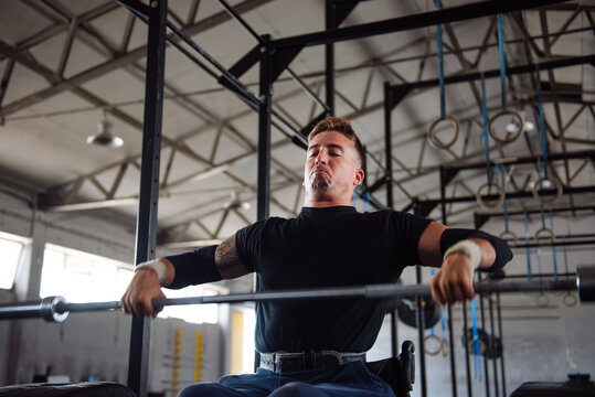 Wheelchair Athlete Lifting Weights in Industrial Gym