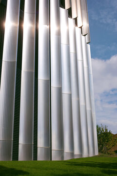 Futuristic Metallic Architectural Building with Geometric Lines, grass