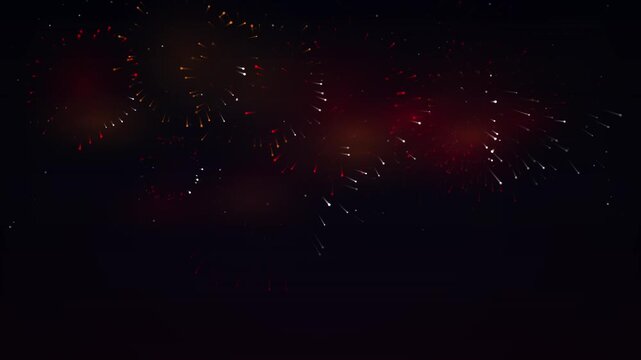 Red and gold fireworks exploding against a dark night sky