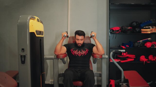 Muscular male athlete doing machine crunches on a seated ab equipment focusing on core conditioning and fitness workout.