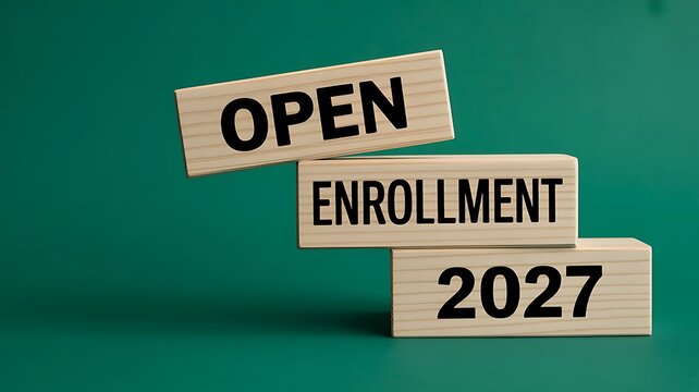Wooden blocks stacked to display open enrollment 2027 on a solid dark green background, representing healthcare insurance, and benefits sign, up period
