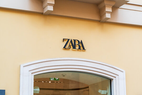 Bari, Italy - Aug 4, 2026: Zara logo in black lettering on a pale yellow facade above an arched shop window with a white stone frame in the city centre shopping district
