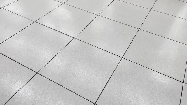 Perspective view of white square ceramic tiles floor pattern