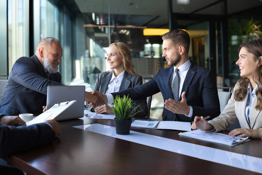 Business people shaking hands, finishing up a meeting.
