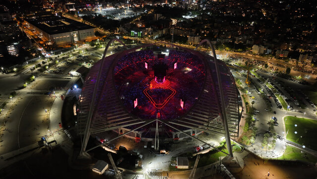 Aerial drone scenic view of live concert illuminated with colorful lights of Anna Vissi popular Greek singer in OAKA sports stadium designed by Santiago Calatrava, Athens, Greece