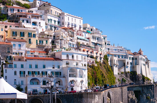 Facades of famous town of Amalfi, located on the Amalfi Coast, with its azure sea and beautiful colorful cliffside houses.