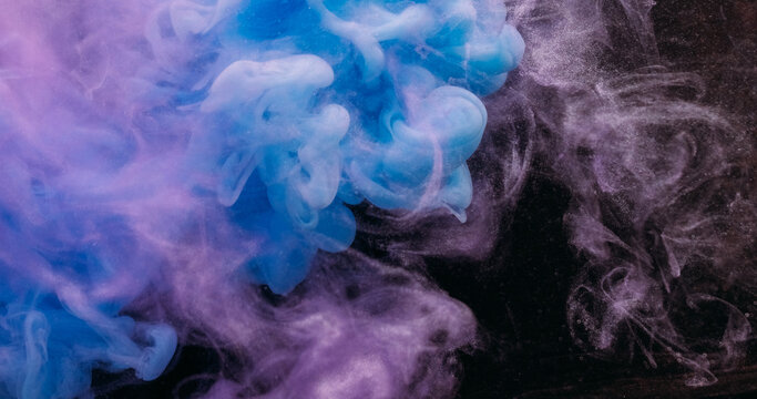 Paint mix. Fume drop explosion. Blur blue purple color water dye liquid particles acrylic cloud texture spreading on abstract art background.