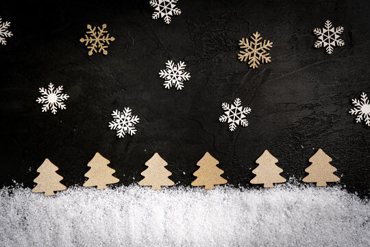 Christmas Holiday background with snow, fir tree and christmas decorations. Christmas fir trees on a winter dark festive background, symbolizing holiday spirit and elegance.