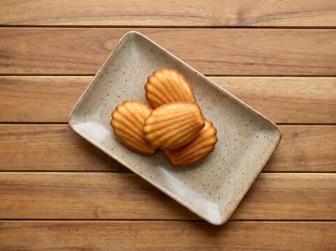 Delicious Madeleines on Ceramic Plate for Bakery or Cafe Menu