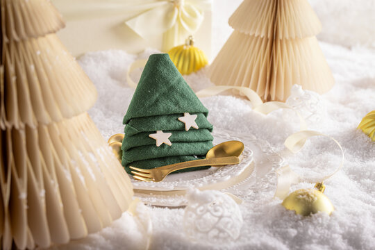 Snowy white table decorated with festive ornaments.