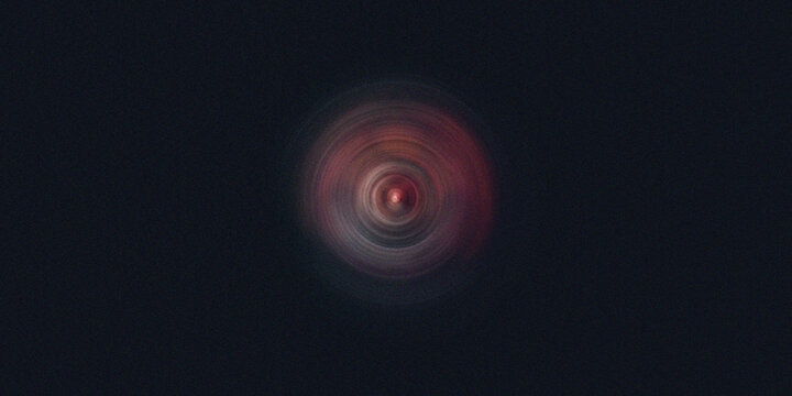 Intense dark vortex with red glow forms hypnotic radial circle pattern for space imagery.
