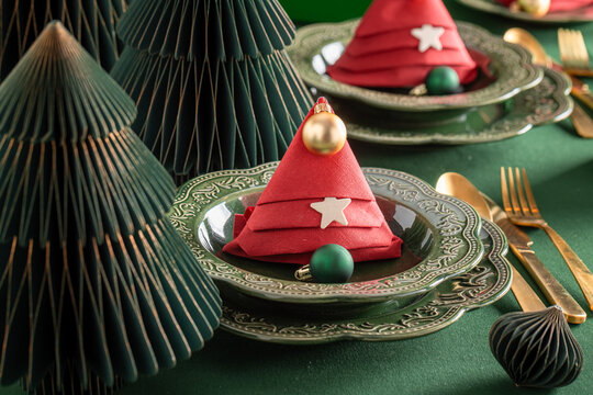 Green festive table setup adorned with baubles.