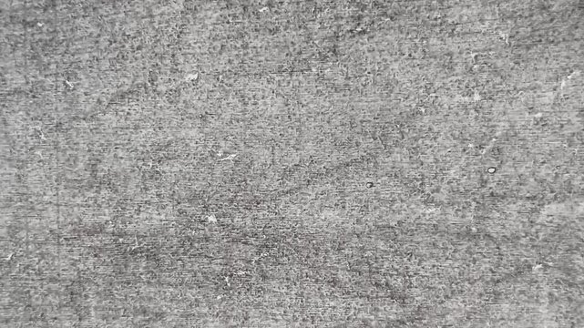 Old aged dirty rough stone wall surface with messy white, grey and black color shade pattern with copy space. Minimal abstract background texture for graphic design use. Stop motion animation loop.