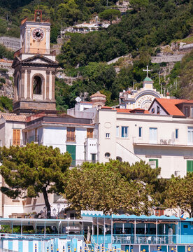 Facades of famous town of Amalfi, located on the Amalfi Coast, with its azure sea and beautiful colorful cliffside houses.