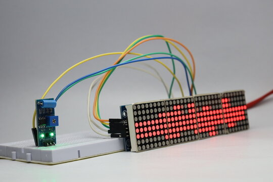 Red dot matrix display module and vibration sensor connected on a breadboard displaying various patterns