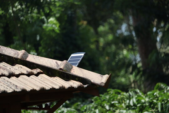 Solar panel installed on rooftop with nature background showing the concept of clean energy