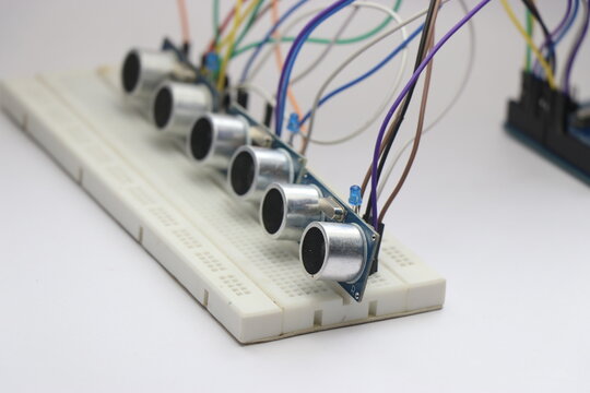Ultrasonic distance sensors arranged on a breadboard with jumper cables connected to a microcontroller for prototyping