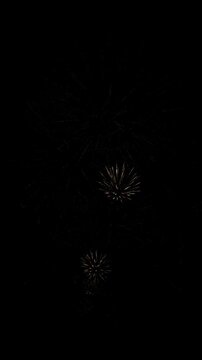 4K. loop seamless of real fireworks background golden shining fireworks with bokeh lights in the night sky. glowing fireworks show. New year's eve fireworks celebration multiple colors 