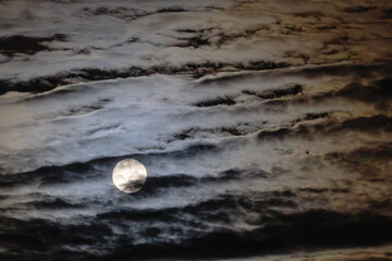 Full moon in cloudy sky © Stanislav