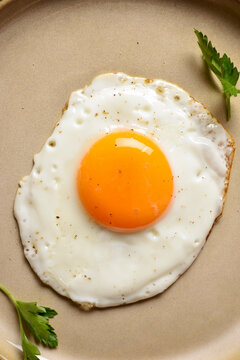 Fried egg on plate, close up view
