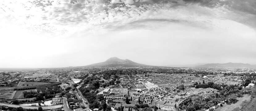 Cinematic aerial view of Pompeii ancient streets and excavated Roman city remains