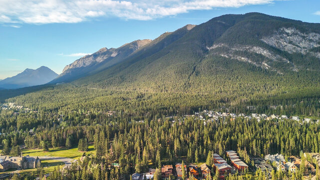 Panoramic aerial shot of Banff National Park with lush green valley in summer